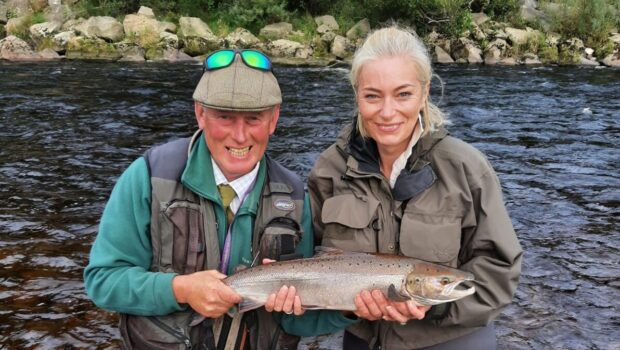 Happy-angler-with-her-fish-alongside-Head-Ghillie-Ian-Tennant-2-e1632684143880-620x350