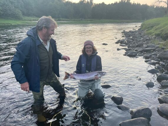 A happy angler and a wet ghillie