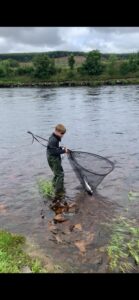 Another one in the net- a young ghillie in the making.