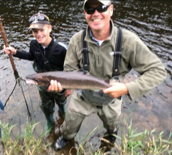 Fisher turned ghillie, Henry nets a fish for his father in Red Craigs