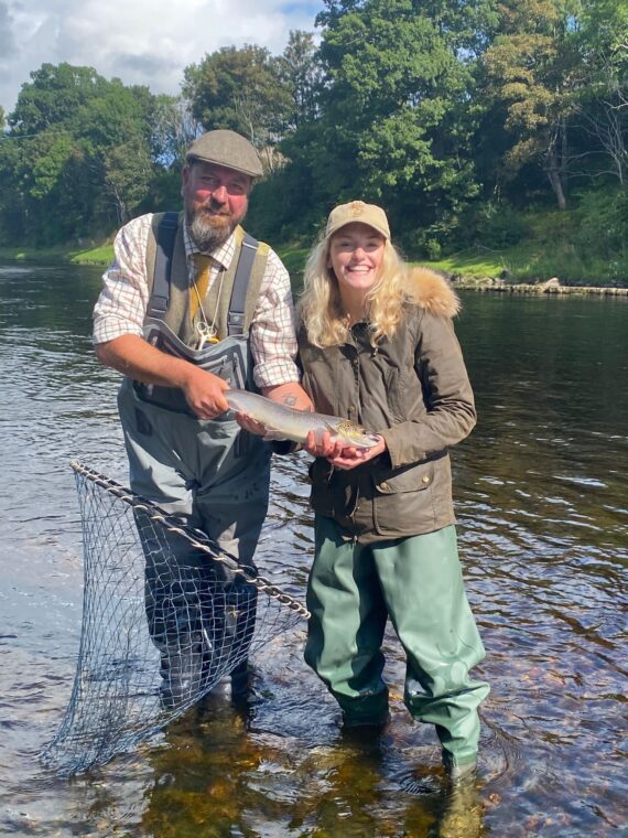 Flo Dowler with her first fish, alongside Head Ghillie Euan Reid