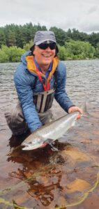 Happy angler with a silver torpedo