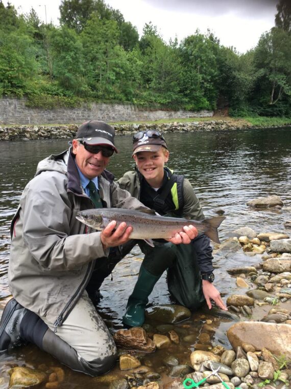 Henry Macrae with a lovely fish, alongside Ghillie Orn Sigurhansson