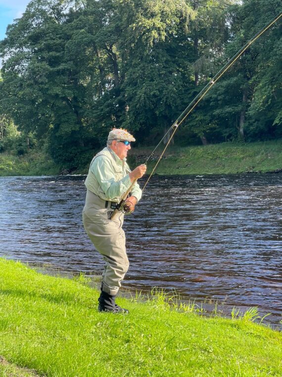 Jack Meredith playing a fish