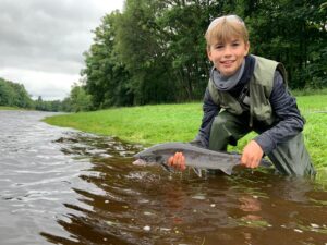 James Robertson with a grilse taken in high coloured water