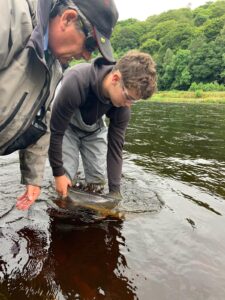 Thomas Robertson releasing a fine 12lb fish in the Fiddich Mouth Pool